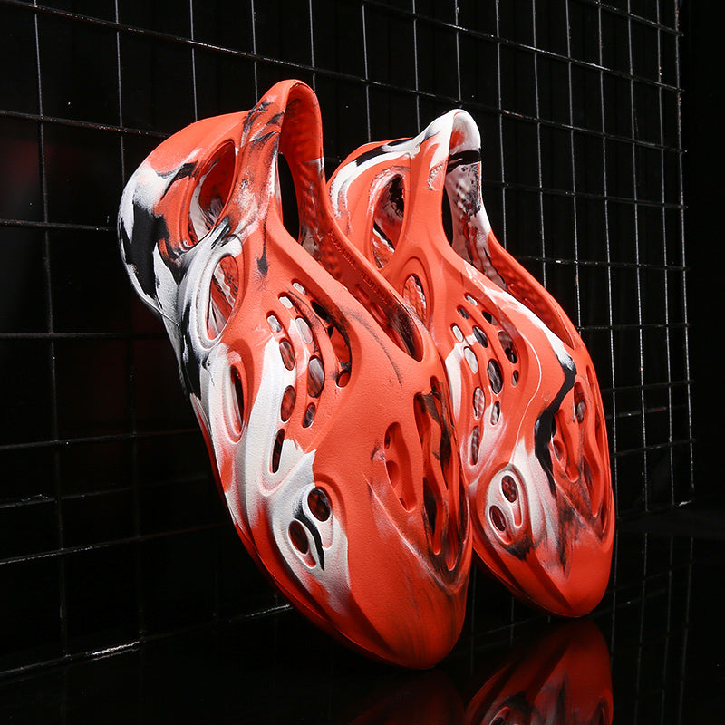 Side profile of Garuda Cloud T84 Foam Runners showing organic ventilation holes