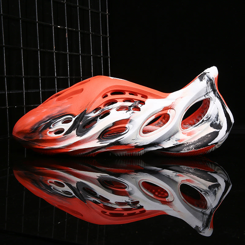 Side profile of Garuda Cloud T84 Foam Runners showing organic ventilation holes