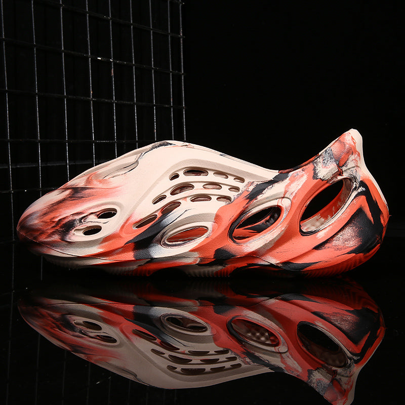 Side profile of Garuda Cloud T84 Foam Runners showing organic ventilation holes