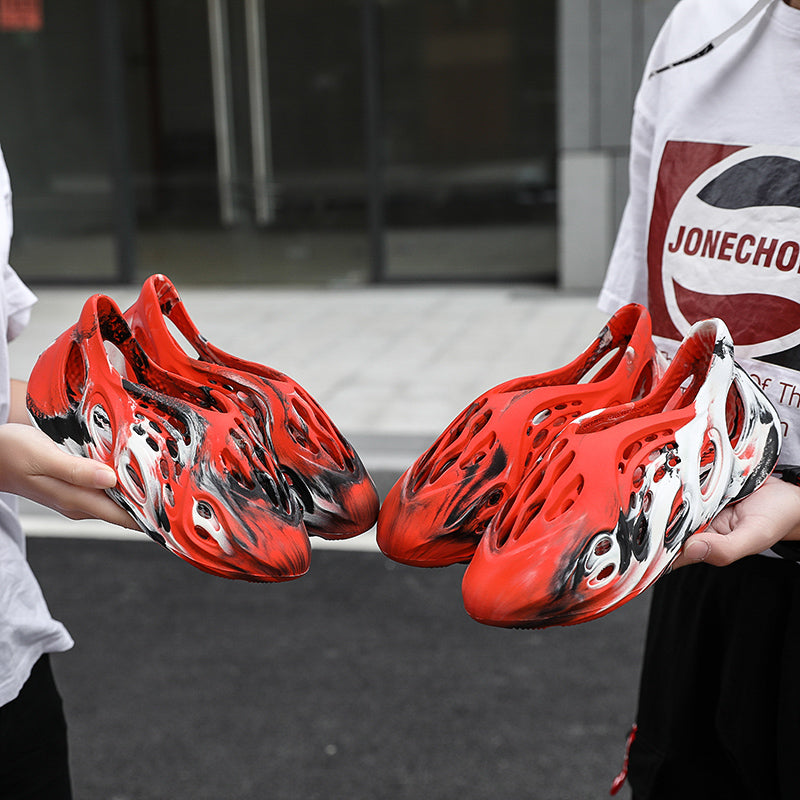 Side profile of Garuda Cloud T84 Foam Runners showing organic ventilation holes