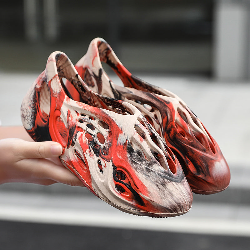 Side profile of Garuda Cloud T84 Foam Runners showing organic ventilation holes
