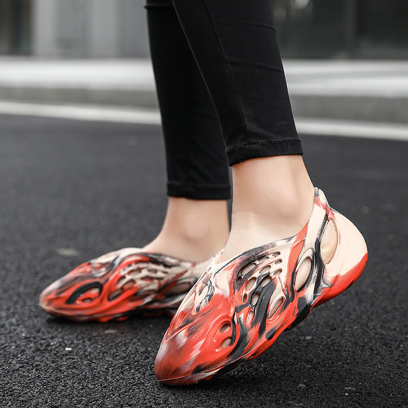 Side profile of Garuda Cloud T84 Foam Runners showing organic ventilation holes