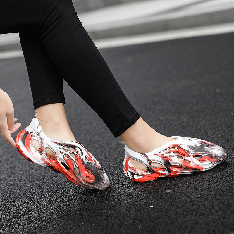 Side profile of Garuda Cloud T84 Foam Runners showing organic ventilation holes