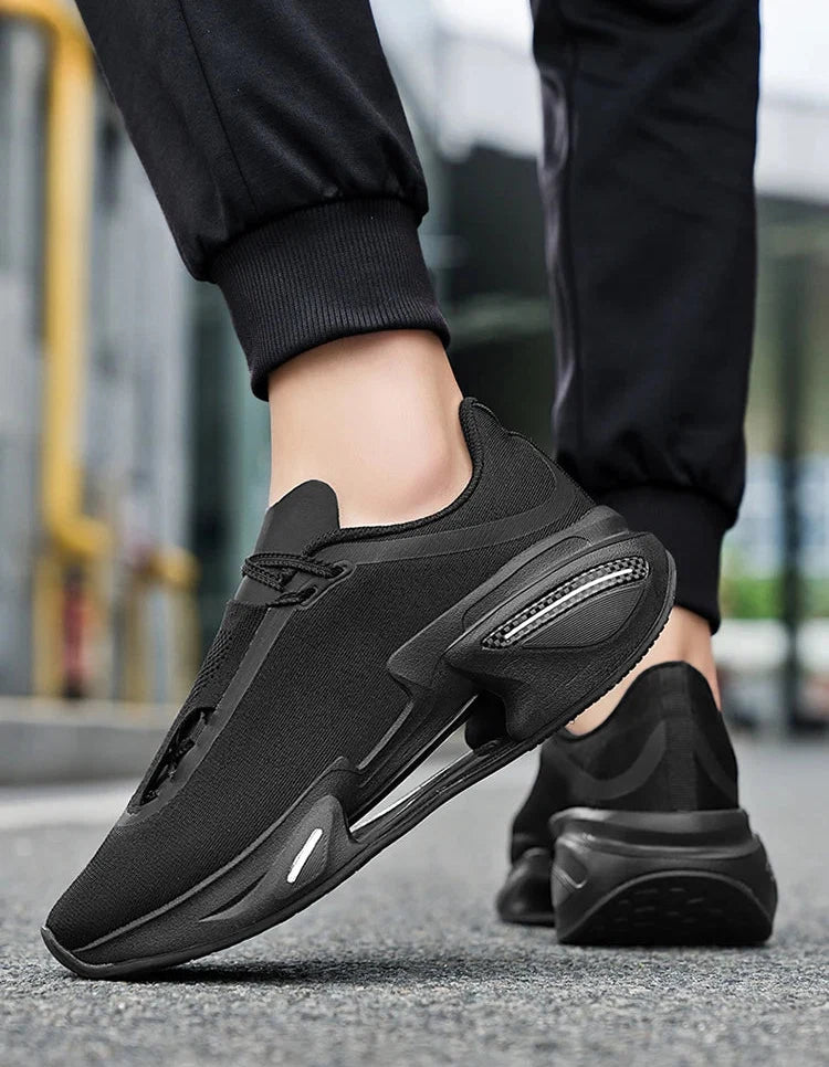 Black athletic shoes worn by a person on a blurred street background