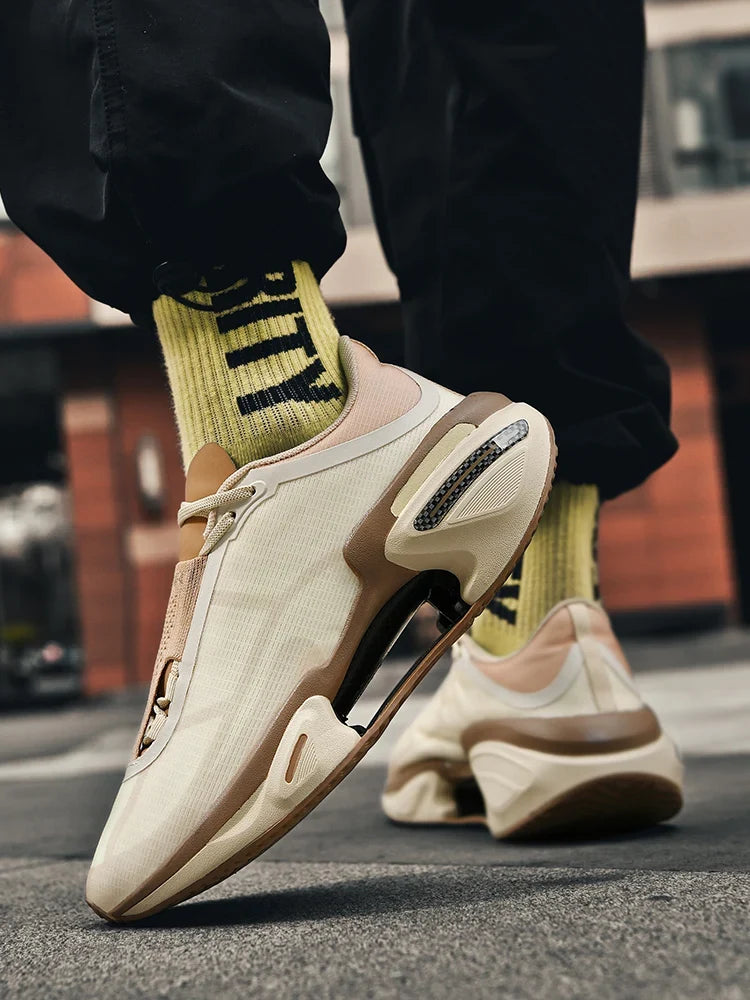 Beige sneakers worn with black pants and yellow socks on a street background
