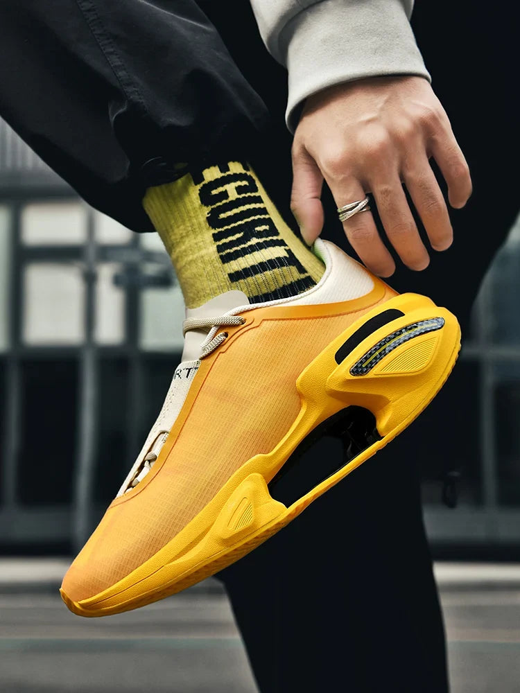 Yellow sneaker with black accents worn by a person, with a blurred background.